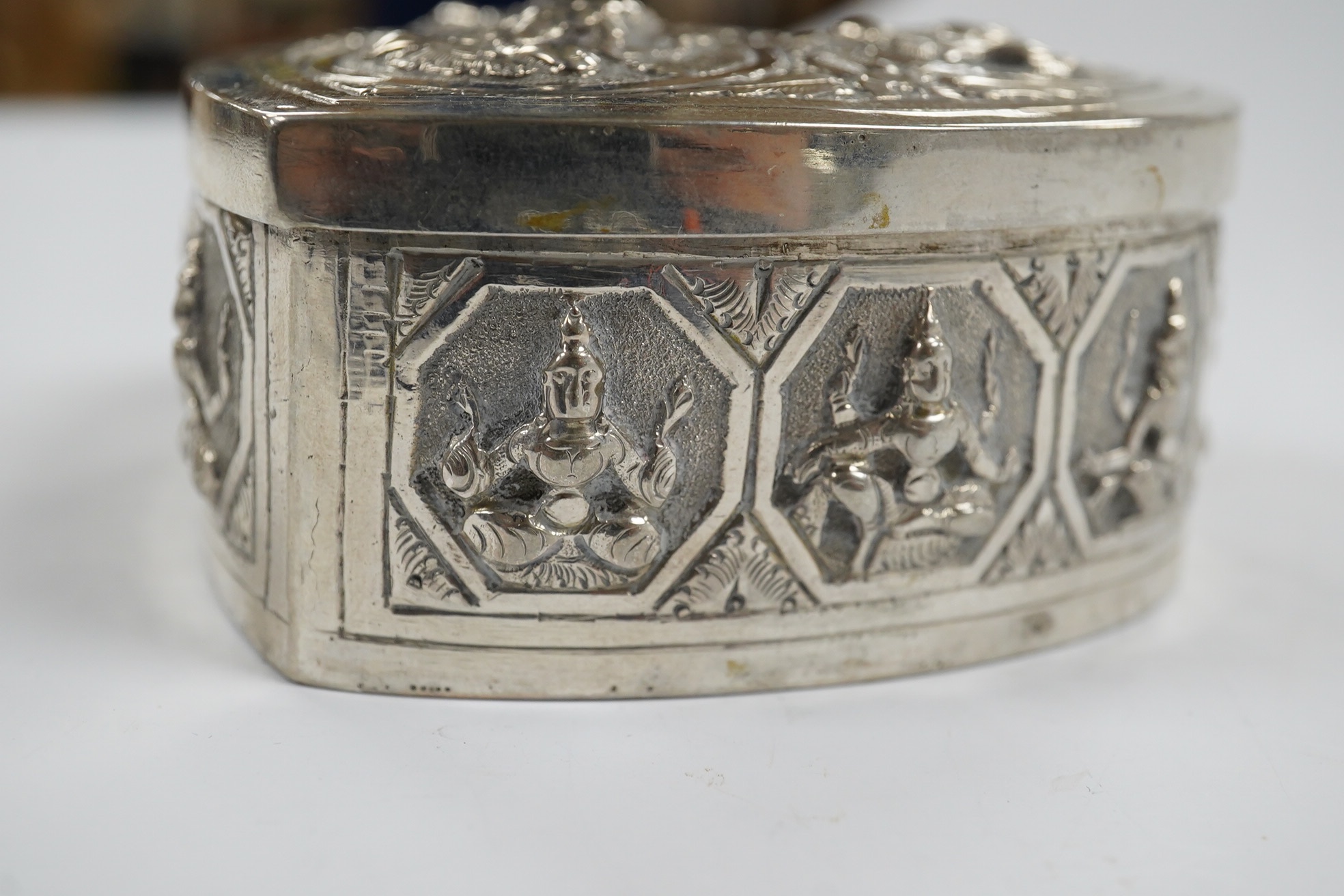 An Indian embossed white metal heart shaped trinket box and cover, width 85mm, 120 grams. Condition - fair